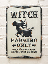 Load image into Gallery viewer, Vintage-style Witch Parking Only metal sign with black witch riding a broomstick, distressed cream background, black lettering, weathered edges, and Violators Will Have a Spell Cast on Them text