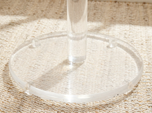 Load image into Gallery viewer, Vintage freestanding clear Lucite coat rack featuring a tall transparent cylindrical column, curved transparent hooks at different heights, and a round clear base.