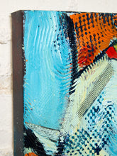 Load image into Gallery viewer, Image 4 of 8: Abstract canvas wall art with thick textured brushstrokes in light blue, orange, cream, black, and small red accents, shown hanging against a white wall.