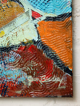 Load image into Gallery viewer, Image 7 of 8: An abstract canvas painting with thick impasto brushstrokes in orange, red, blue, white, black, and brown, mounted on a white brick wall.