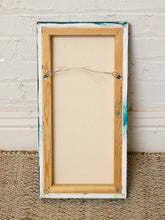 Load image into Gallery viewer, Image 8 of 8: The back view of a framed canvas print, showing the wooden frame, wire hanger, and textured white brick wall background.