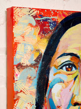 Load image into Gallery viewer, Image 4 of 8: A close-up of a colorful canvas painting showing part of a woman's face with expressive brushstrokes in red, yellow, blue, black, and pink, mounted against a light textured wall.