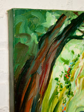Load image into Gallery viewer, A close-up of a textured canvas painting depicting a tree trunk with green, yellow, and brown brushstrokes, mounted on a white brick wall.