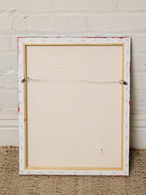 Load image into Gallery viewer, The back of a framed canvas print, showing the wooden stretcher bar, wire hanging system, and textured off-white canvas, leaning against a white brick wall on a woven rug.