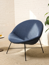 Load image into Gallery viewer, Image 1 of 17: Blue upholstered lounge chair by Claude Vassal featuring a wide rounded backrest, softly curved bowl-shaped seat, and slender black metal legs with angled supports.