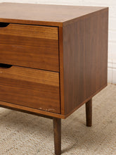Load image into Gallery viewer, Image 10 of 16: Vintage mid-century modern wooden nightstand featuring two stacked drawers with recessed crescent-shaped pulls, warm walnut-tone wood grain, rectangular cabinet frame, and four slender tapered legs.