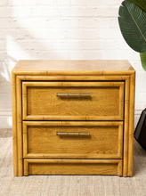 Load image into Gallery viewer, Image 7 of 21: Vintage honey oak nightstand featuring two drawers, natural wood grain, rounded faux-bamboo trim, and antique brass-tone horizontal handles, available as a pair.