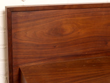 Load image into Gallery viewer, Image 9 of 22: Close-up of a dark brown wooden furniture piece, showing the rich wood grain and a corner joint against a white brick wall background.