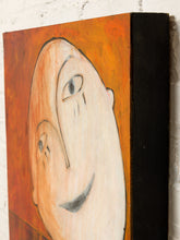 Load image into Gallery viewer, Image 6 of 8: A close-up of a textured canvas painting featuring an abstract, stylized face with a large cream-colored oval head and expressive eyes against a warm orange background, shown hanging on a white brick wall.