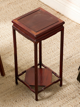 Load image into Gallery viewer, Image 6 of 16: A dark reddish-brown wooden side table with a square top, four legs, and a lower open shelf, shown on a textured beige rug.