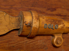Load image into Gallery viewer, Image 3 of 9: A close-up of a vintage wooden golf club shaft with the brand name 'DOLG' in dark metal lettering, resting on a rustic wooden surface.