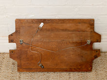 Load image into Gallery viewer, Image 9 of 9: A rustic wooden board with notched cutouts on the sides, showing the back side with metal hanging hardware against a white brick wall and woven rug background.