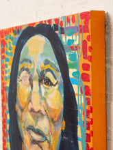 Load image into Gallery viewer, Image 6 of 8: A close-up of a colorful canvas painting showing part of a face with dark hair, painted in yellow, blue, red, and orange tones, mounted against a light wall.