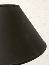 Load image into Gallery viewer, Image 18 of 18: A close-up of a black fabric lampshade against a white painted brick wall background.
