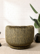 Load image into Gallery viewer, Image 5 of 16: Rowan Swivel Chair in Kenai Olive featuring olive, mustard, and charcoal abstract linear patterned upholstery, a rounded barrel backrest, curved arms, a generously cushioned seat, and a low-profile circular swivel base.