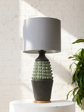 Load image into Gallery viewer, Image 1 of 17: Vintage table lamp with light gray drum shade and textured sage green and charcoal brown sculptural base