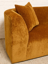 Load image into Gallery viewer, Image 8 of 16: A close-up of a mustard yellow velvet loveseat with a matching throw pillow, set against a white brick wall and light-colored rug.