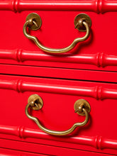 Load image into Gallery viewer, Image 14 of 21: Close-up of a bright red drawer front with two brass pull handles and decorative drawer rail details.