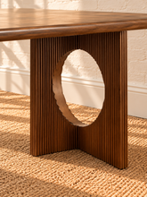 Load image into Gallery viewer, Sylvia dining table in Natural Brown Walnut with rectangular rounded-edge top and sculptural fluted pedestal bases with circular cutouts.
