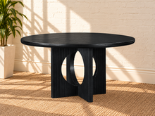 Load image into Gallery viewer, Sylvia round dining table in Charcoal with black oak veneer finish, fluted pedestal base, and distinctive circular cutouts.