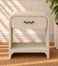 Load image into Gallery viewer, Thiago Greige linen-textured nightstand with rounded frame, drawer, matte black wave handle, and open lower shelf.