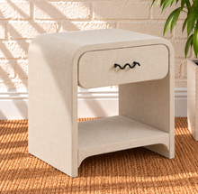 Load image into Gallery viewer, Thiago Greige linen-textured nightstand with rounded frame, drawer, matte black wave handle, and open lower shelf.
