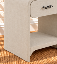 Load image into Gallery viewer, Thiago Greige linen-textured nightstand with rounded frame, drawer, matte black wave handle, and open lower shelf.