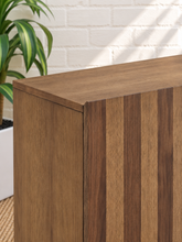 Load image into Gallery viewer, Veda warm oak bar cabinet with alternating vertical oak and walnut veneer striped doors and raised wood legs