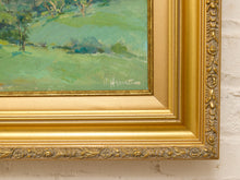 Load image into Gallery viewer, Original Felice Hrovat landscape painting with rolling green hills, mature trees and deep blue mountains in an ornate gold-tone frame.