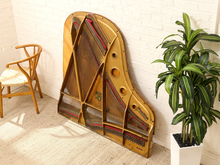 Load image into Gallery viewer, Deconstructed piano harp with gold-tone cast metal frame, exposed strings, tuning pins, red felt, and aged patina