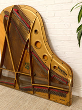 Load image into Gallery viewer, Deconstructed piano harp with gold-tone cast metal frame, exposed strings, tuning pins, red felt, and aged patina