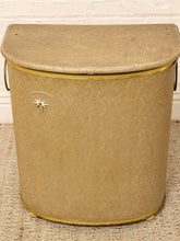 Load image into Gallery viewer, Vintage beige Atomic Age clothes hamper with rounded lid, brass-tone trim, textured patterned finish, and metal starburst accent