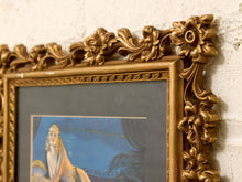 Load image into Gallery viewer, An ornate gold-colored frame with intricate floral carvings, holding a blue-toned painting, shown against a textured off-white wall.