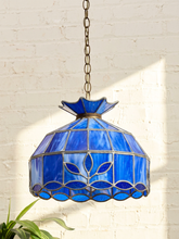 Load image into Gallery viewer, Vintage Tiffany-style pendant lampshade with cobalt blue stained glass panels, dark metal leading, decorative border, and chain