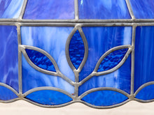 Load image into Gallery viewer, Close-up of a stained glass panel featuring blue and white marbled glass sections divided by a silver-toned metal grid in a leaf-like pattern.