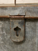 Load image into Gallery viewer, Close-up of a weathered metal latch with a cross-shaped cutout on a textured gray surface.