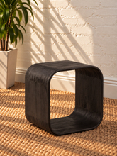 Load image into Gallery viewer, Walter side table in Midnight Cafe Mindi wood with a rounded rectangular top, curved arch-style sides, and visible natural wood grain.