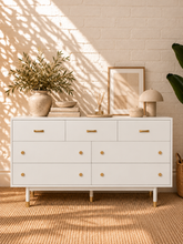 Load image into Gallery viewer, Image 2 of 4: Yvette 7-drawer dresser in Chalk White with polished gold details and elevated legs