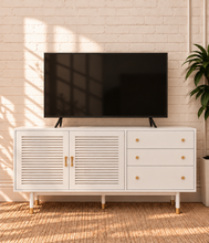 Load image into Gallery viewer, Image 2 of 4: Yvette TV stand in Chalk White with three drawers, two-door storage cabinet, gold details, and elevated legs