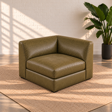 Load image into Gallery viewer, Image 6 of 8: Lucero olive-toned leather square corner unit with one seat cushion and two adjoining upholstered backrests on a plain beige rug.
