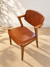 Load image into Gallery viewer, Image 6 of 89: T-Rex dining chair in Cantina Saddle brown upholstery with wood frame — styled visualization