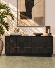 Load image into Gallery viewer, Long black credenza with dimensional staggered geometric wood cabinet fronts, subtle wood grain, and low architectural base.
