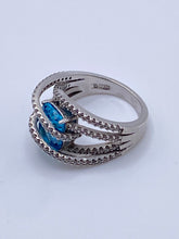 Load image into Gallery viewer, Sterling Silver Blue Topaz Bypass Ring with Cubic Zirconia Accents
