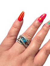 Load image into Gallery viewer, Sterling Silver Blue Topaz Bypass Ring with Cubic Zirconia Accents

