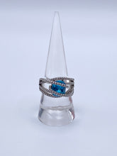 Load image into Gallery viewer, Sterling Silver Blue Topaz Bypass Ring with Cubic Zirconia Accents
