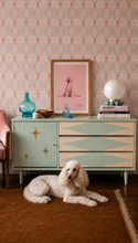 Load image into Gallery viewer, Vintage Atomic mid-century dresser in mint green and cream with three geometric diamond drawers, gold starburst cabinet door and tapered legs.
