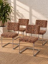 Load image into Gallery viewer, Modern 70s-style dining chair with terracotta and black tiger-print upholstery and polished chrome cantilever frame
