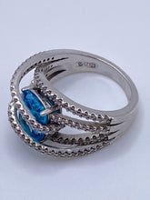 Load image into Gallery viewer, Sterling Silver Blue Topaz Bypass Ring with Cubic Zirconia Accents
