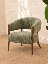 Load image into Gallery viewer, Abby accent chair upholstered in textured sage amber bouclé with curved wraparound backrest, cushioned seat and exposed brown wood legs.
