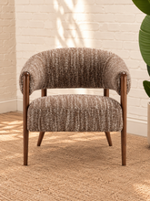 Load image into Gallery viewer, Abby mocha textured bouclé accent chair with curved wraparound backrest, cushioned seat and exposed brown solid wood legs.
